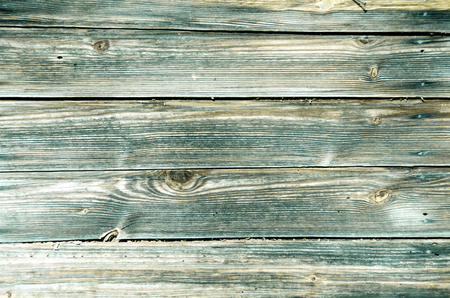 Fragment of the wall of the old wooden house in the Belorussian village. Beautiful vintage background of wooden boards with colorful texture. Copy space to add your text.の写真素材