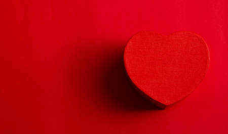 Red heart on red background with space for text. Flat lay, top viewの写真素材