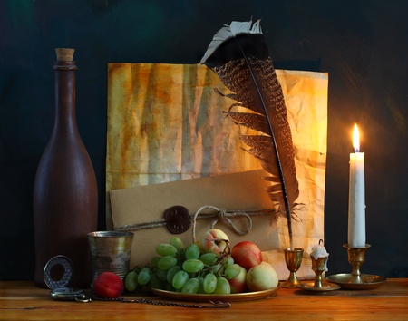 still life with fruit, old letters with a pen and a candleの写真素材