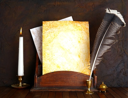 Old paper with a candle and a quill pen.の写真素材