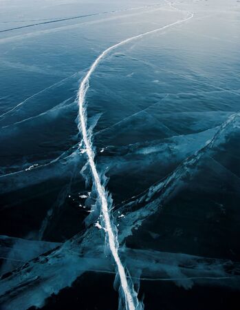 Beautiful ice of Lake Baikal with abstract cracks