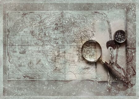Vintage magnifying glass, compass  lying on an old map. 