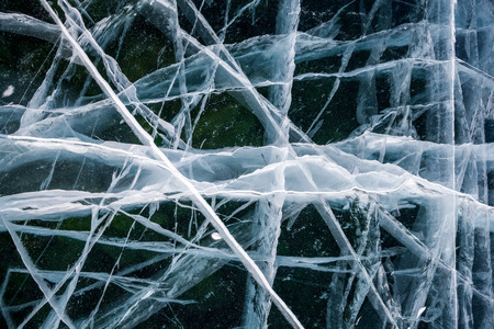 ice texture on a lake water in winter outdoors with snowの写真素材