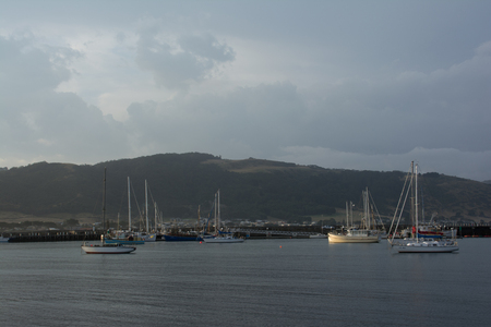 boats sitting calmly in the water of a marina at sunset.のeditorial素材