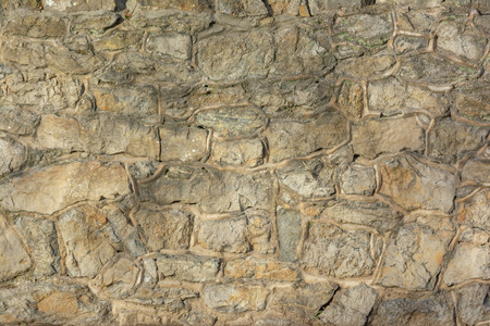 Old stacked stone wall backgroundの写真素材