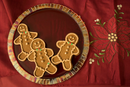 Gingerbread cookies with perfect royal icing on red mosaic glass plateの写真素材