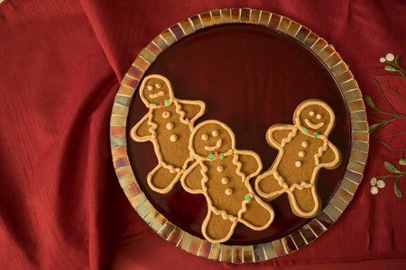Gingerbread cookies with perfect royal icing on red mosaic glass plate