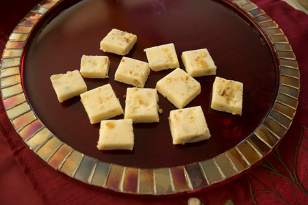 Holiday white chocolate fudge on red mosaic tile plateの写真素材