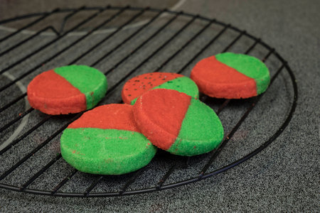 Red and Green two tone butter cookies on wire cooling rackの写真素材