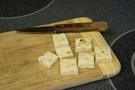 White chocolate fudge on bamboo cutting board with knifeの写真素材