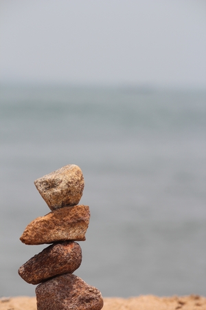 Assembling stones on beachの写真素材