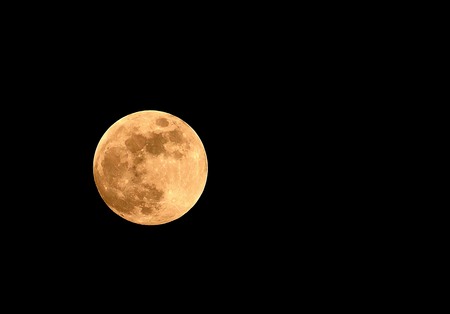 Full moon on dark black backgroundの写真素材