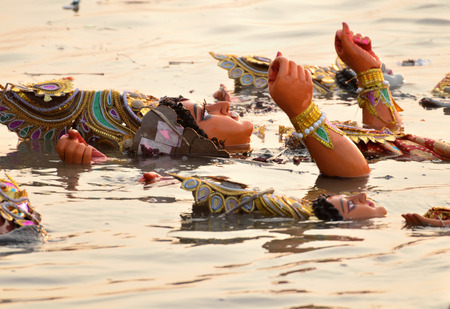 Immersion of goddess durga idol in river after completion of festivalの写真素材