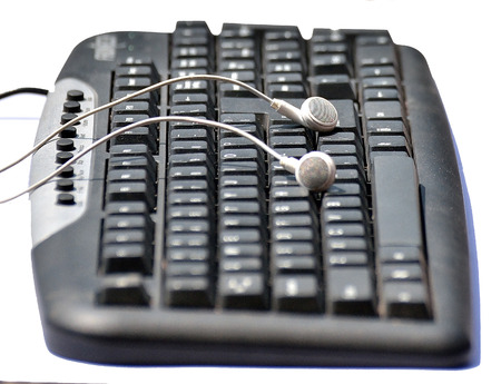 Headphone and keyboard on isolated white background