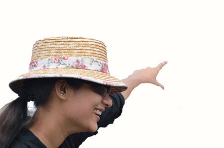 Girl with hat pointing somethingの写真素材