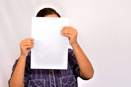 Young girl is reading a paper.の写真素材