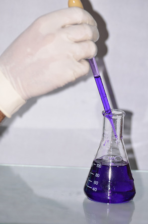 A boy was doing chemical reaction in a chemistry laboratoryの写真素材