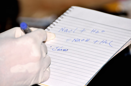 A boy was writing note in a chemistry laboratoryの写真素材