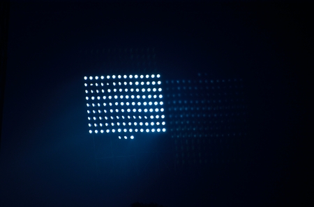 Stadium floodlights against a dark night sky background .の写真素材