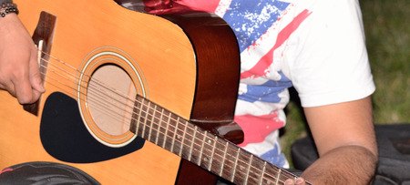Close-up of a man playing a guitar.の写真素材