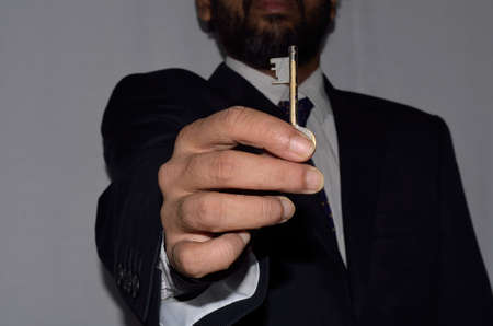 Photo of a young businessman how holding key.の写真素材