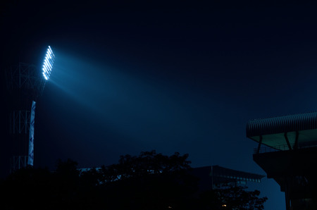 Stadium floodlights against a dark night sky background .の写真素材