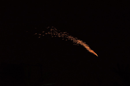 In a festival fireworks display in night sky.