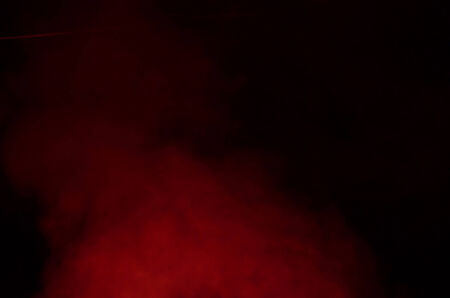 Red smoke of fireworks in a night.の写真素材