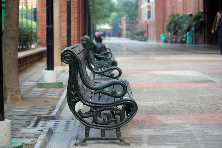 Empty Wooden and iron bench on the seaside in footpath.の写真素材