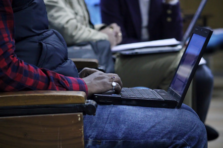 Man typing in a laptop in a educational conference.の写真素材