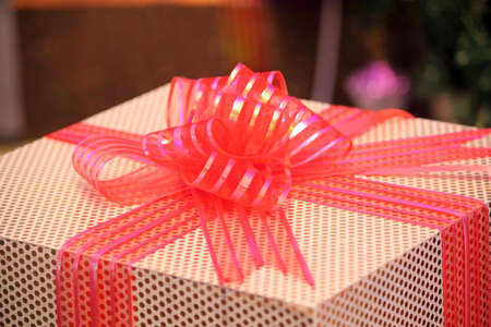 wrapped box with orange ribbon bow,