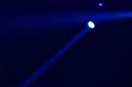 Beam of blue light on black . Applied to a searchlight torch.の写真素材