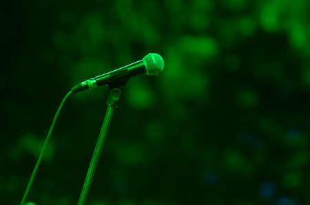 Close-up of microphone in green light.の写真素材