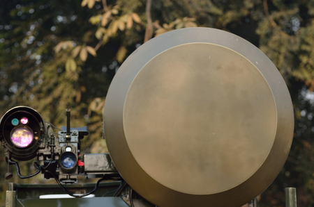 Air surveillance radar in forest.