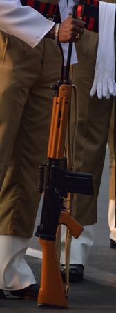 Indian army men with gun.