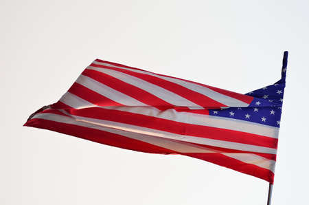 American flag is flying in white background.の写真素材
