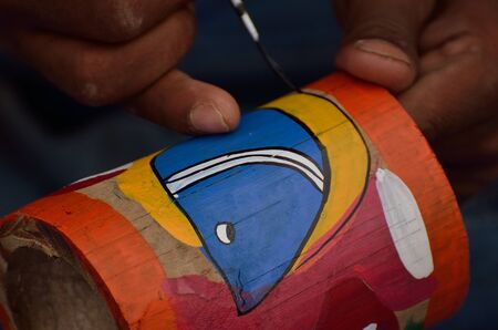 A man painting with brush.