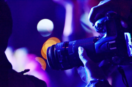 Photographer taking photo with SLR camera