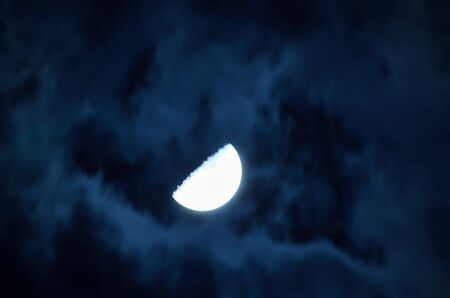 Half moon and cloud in night sky.の写真素材