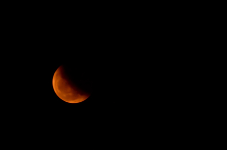 moon eclipse. Red and Orange moon in a night sky.