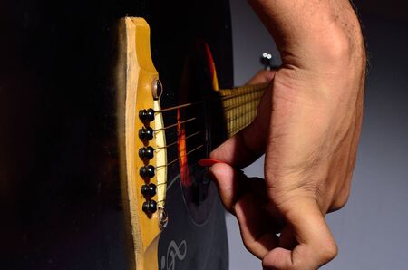 A guitarist playing acoustic guitar.