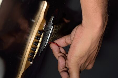 A guitarist playing acoustic guitar.