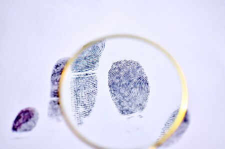 Magnifying glass with fingerprint on the white backgrounの写真素材