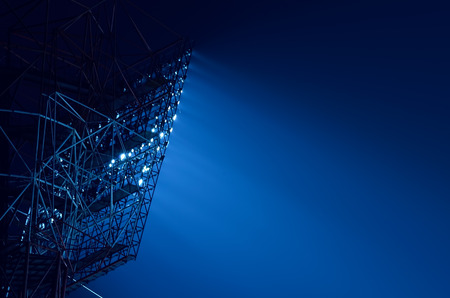 Closeup of stadium floodlights against a dark night sky backgroundの写真素材
