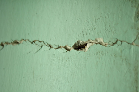 Cracks appearing in an interior wall of house.の写真素材