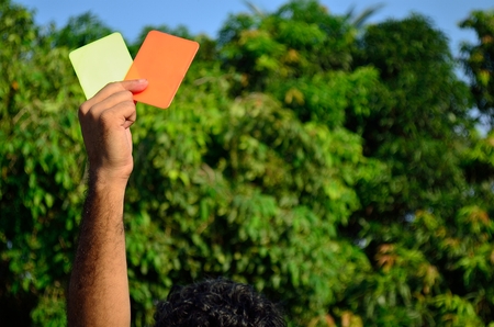 Soccer referee while showing red cardの写真素材