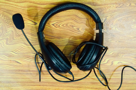 Headphones on a wooden tableの写真素材