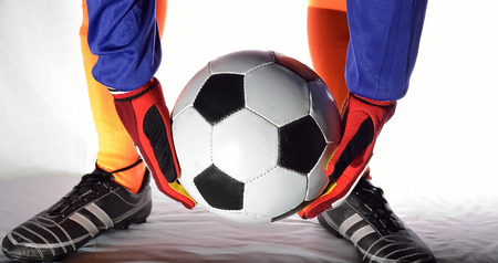 Soccer goalkeeper holding ball.