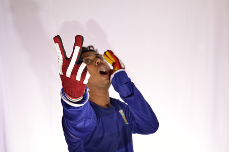 Soccer goalkeeper in shouting white background.の写真素材
