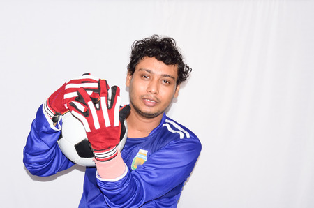 Soccer goalkeeper is holding a soccer ball.の写真素材